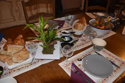 a table with a plate of food and glasses of wine at Villa Lumières in Goult