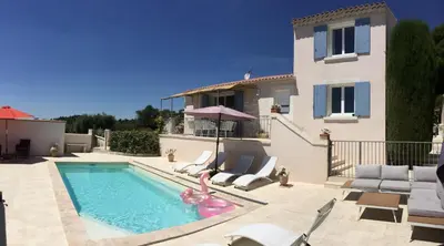 a villa with a swimming pool and a house at Vacation rental in the Alpilles, Provence, close to the village center - Beautiful view -Air conditionning Heated pool and spa - sleeps 8 in Aureille