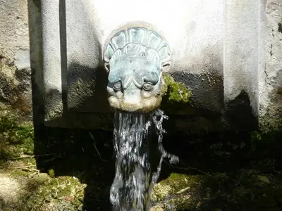 a water fountain with a face on it at Vacation rental in the Alpilles, Provence, close to the village center - Beautiful view -Air conditionning Heated pool and spa - sleeps 8 in Aureille