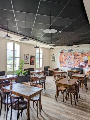 a restaurant with tables and chairs and a mural at Le Nesk Ventoux - Hotel in Sault-de-Vaucluse
