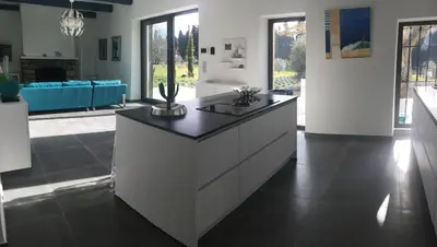a kitchen with a large island in a living room at provencal farm house with heated pool located to salon de provence, 12 people in Salon-de-Provence