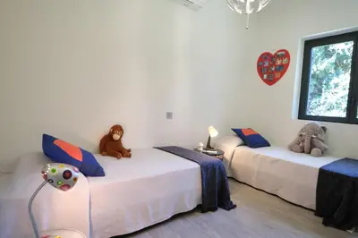 two beds in a room with stuffed animals on them at provencal farm house with heated pool located to salon de provence, 12 people in Salon-de-Provence