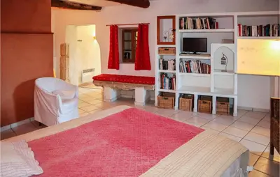 a living room with a couch and a red rug at Cozy Apartment In Villes Sur Auzon in Villes-sur-Auzon