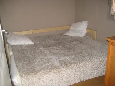 a bedroom with a bed with two pillows at Gite des Ocres in Villars