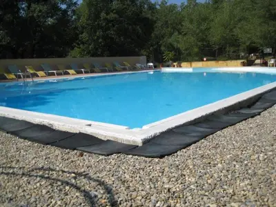 a large swimming pool with chairs on the ground at Gite des Ocres in Villars