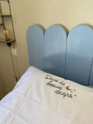 a bed with a pillow that says dont beamed stays at Gite des amis Domaine de Mas Caron in Caromb