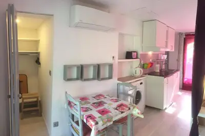 a small kitchen with a table and a table and chairs at L’ocabée in La Tour-dʼAigues