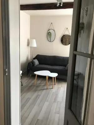 a living room with a couch and a table at Au cœur de Céreste in Céreste