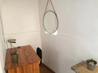 a room with a table and a mirror on the wall at Maison de village - Monteux centre - Provence in Monteux