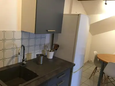 a kitchen with a sink and a refrigerator at Maison de village - Monteux centre - Provence in Monteux