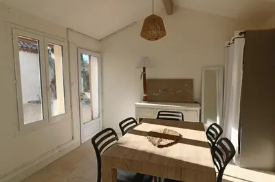 a dining room with a wooden table and chairs at Le mas Sainte Marie in Venasque