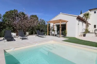 a swimming pool in front of a house at Le mas Sainte Marie in Venasque