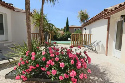 a bunch of pink roses in front of a house at Le mas Sainte Marie in Venasque