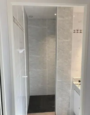 a shower with a glass door in a bathroom at Le Bastidon de L Olivier in Gordes