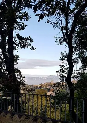a view of a city from behind a fence at Mas du Kairos - Gite Romarin in Venasque