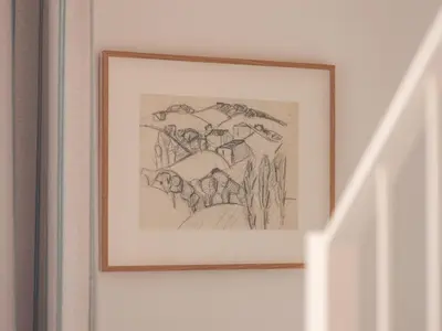 a framed drawing of people on a wall at Hôtel Saint Christophe Aix en Provence Centre Ville in Aix-en-Provence