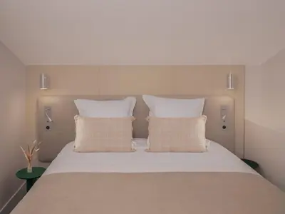 a bedroom with a large bed with two pillows at Hôtel Saint Christophe Aix en Provence Centre Ville in Aix-en-Provence
