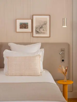 a bedroom with a bed with white pillows at Hôtel Saint Christophe Aix en Provence Centre Ville in Aix-en-Provence