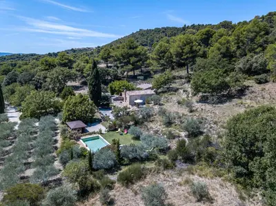 an aerial view of a home with a pool and trees at la petite maison in Vaugines