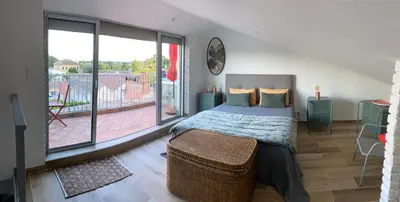 a bedroom with a bed and a large window at LE BELVEDERE in LʼIsle-sur-la-Sorgue