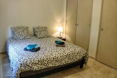 a bedroom with a bed with a lamp on it at Villa piscine face au grand luberon Cereste in Céreste
