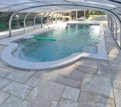a pool of water in a building at Maison charmante au Thor + Piscine in Le Thor