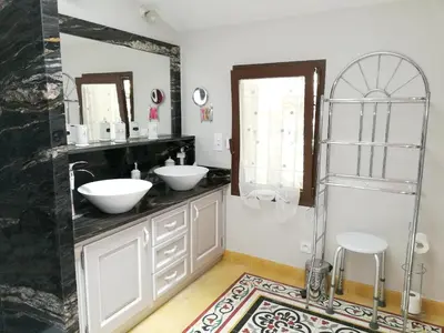 a bathroom with two sinks and a mirror at Maison charmante au Thor + Piscine in Le Thor