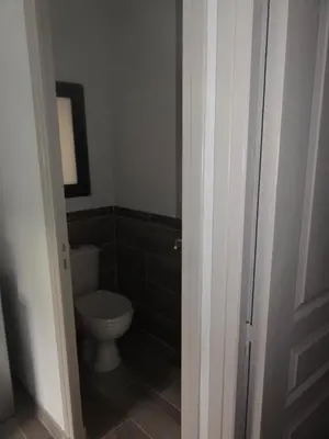 a bathroom with a toilet and a door open at Gite le bagnol un coin de paradis in Maubec