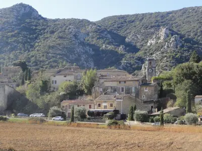 a village in front of a mountain at Gite le bagnol un coin de paradis in Maubec