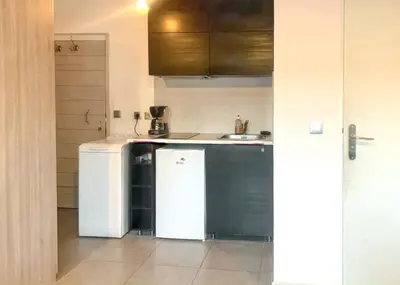 a kitchen with a white refrigerator and a sink at Studio moderne à Aix-en-Provence - 20 m² avec terrasse ! in Aix-en-Provence
