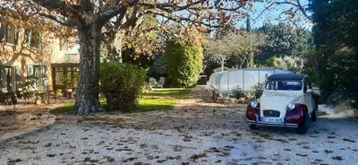 an old red and white truck parked in a driveway at Maison Le Thor avec piscine part. in Le Thor