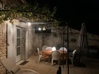 a table and chairs on a patio at night at La Forge - Gordes in Gordes