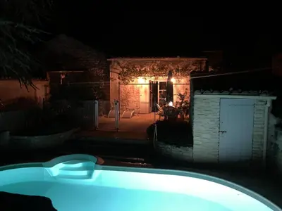 a bath tub in front of a house at night at La Forge - Gordes in Gordes
