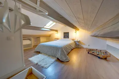 a bedroom with a large bed in a attic at Bel appart pour 6 p, clim, parking et terrasse in Aix-en-Provence