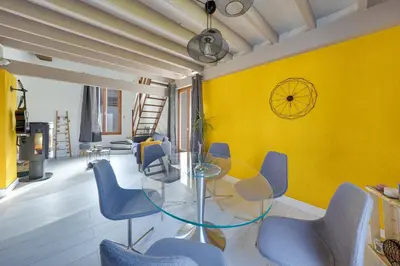 a dining room with a glass table and blue chairs at Bel appart pour 6 p, clim, parking et terrasse in Aix-en-Provence