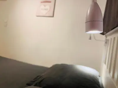 a lamp sitting next to a couch with a pillow at MAZZARIN STUDIO in Aix-en-Provence