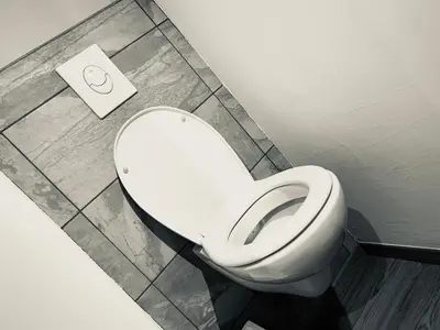 a bathroom with a white toilet in a room at MAZZARIN STUDIO in Aix-en-Provence