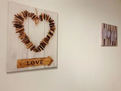 a heart hanging on a wall with a wooden frame at MAZZARIN STUDIO in Aix-en-Provence