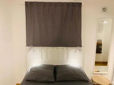 a bed in a room with a window and a bedvisor at MAZZARIN STUDIO in Aix-en-Provence