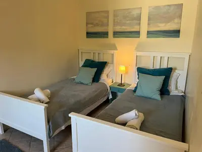 a bedroom with two beds with pillows at The Willow Tree in Le Thor