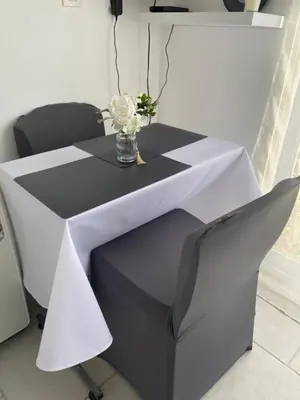 a black and white table with a vase of flowers on it at Chambre privée indépendante au cœur du Luberon in Saint-Saturnin-les-Apt