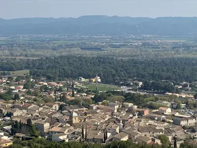 an aerial view of a town with houses and trees at Maison de famille au coeur du Luberon in Mérindol