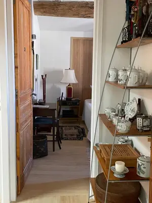 a hallway with a room with a desk and a table with a lamp at La Cour Carrée in Rustrel