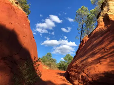 a view of the sky from between two rock formations at La Cour Carrée in Rustrel