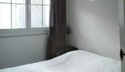 a bedroom with a white bed and a window at Charmante villa à Dauphin avec piscine privée et jardin in Dauphin