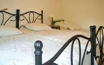 a bedroom with two beds with white sheets at Villa charmante à Dauphin avec piscine privée in Dauphin