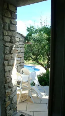 a patio with white chairs and a table and a pool at Villa charmante à Dauphin avec piscine privée in Dauphin