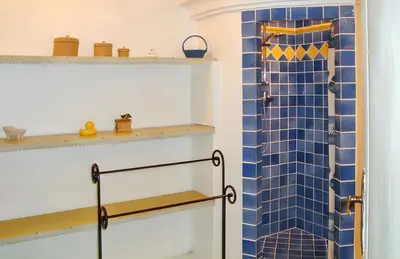 a bathroom with a shower with blue tiles at Villa charmante à Dauphin avec piscine privée in Dauphin