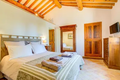 a bedroom with a bed with towels on it at Les Chambres du Perussier in Cucuron