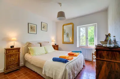 a bedroom with a bed with towels on it at Les Chambres du Perussier in Cucuron